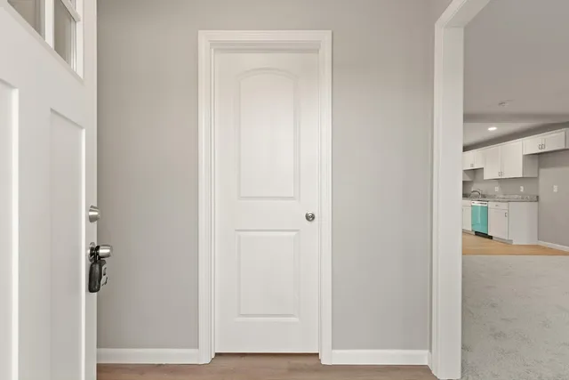a view of a hallway with wooden floor