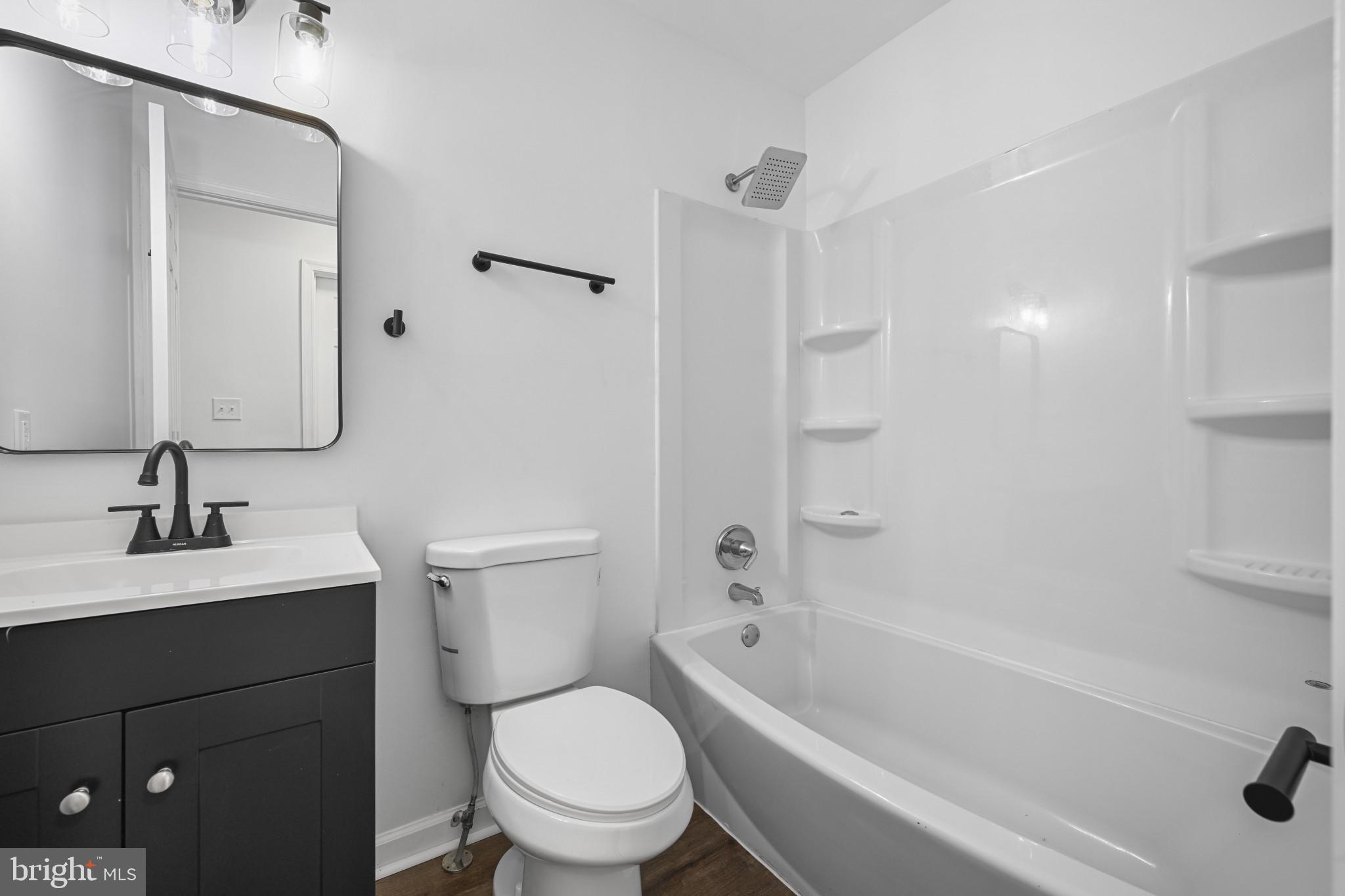 1024 Gringo Lane Lusby, MD 20657 - Photo 14 of 25 a bathroom with a sink toilet vanity and shower