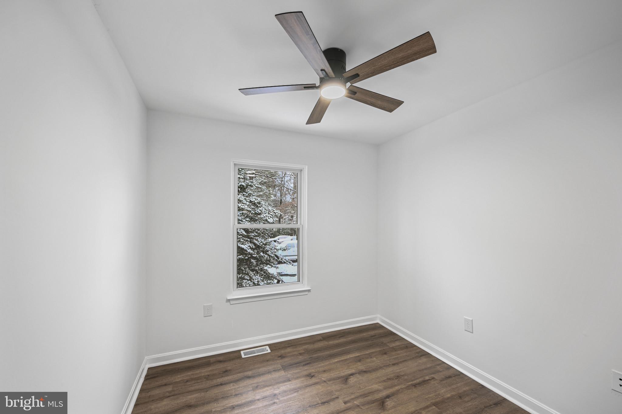 1024 Gringo Lane Lusby, MD 20657 - Photo 15 of 25 an empty room with wooden floor and windows