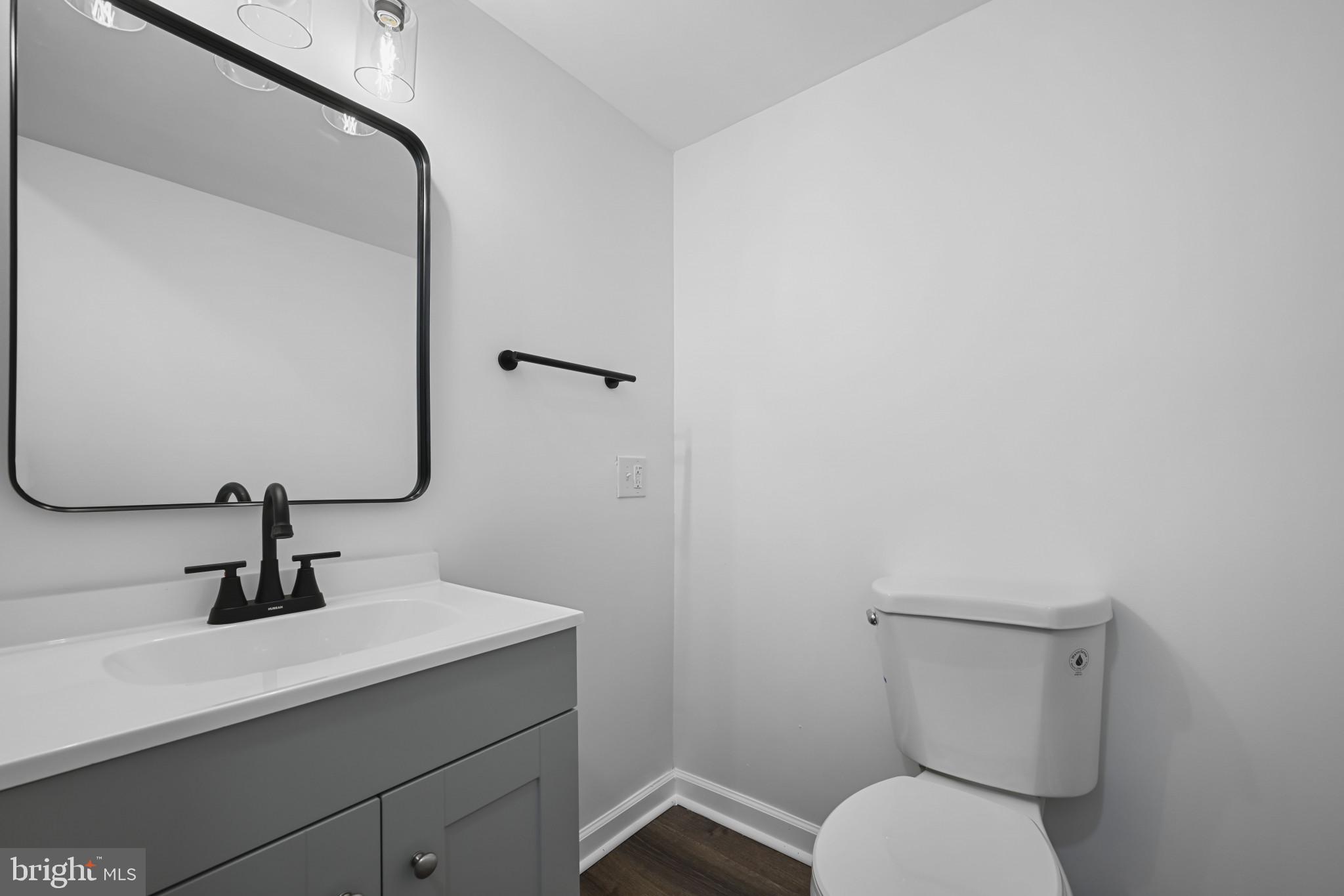 1024 Gringo Lane Lusby, MD 20657 - Photo 8 of 25 a bathroom with a toilet sink and mirror