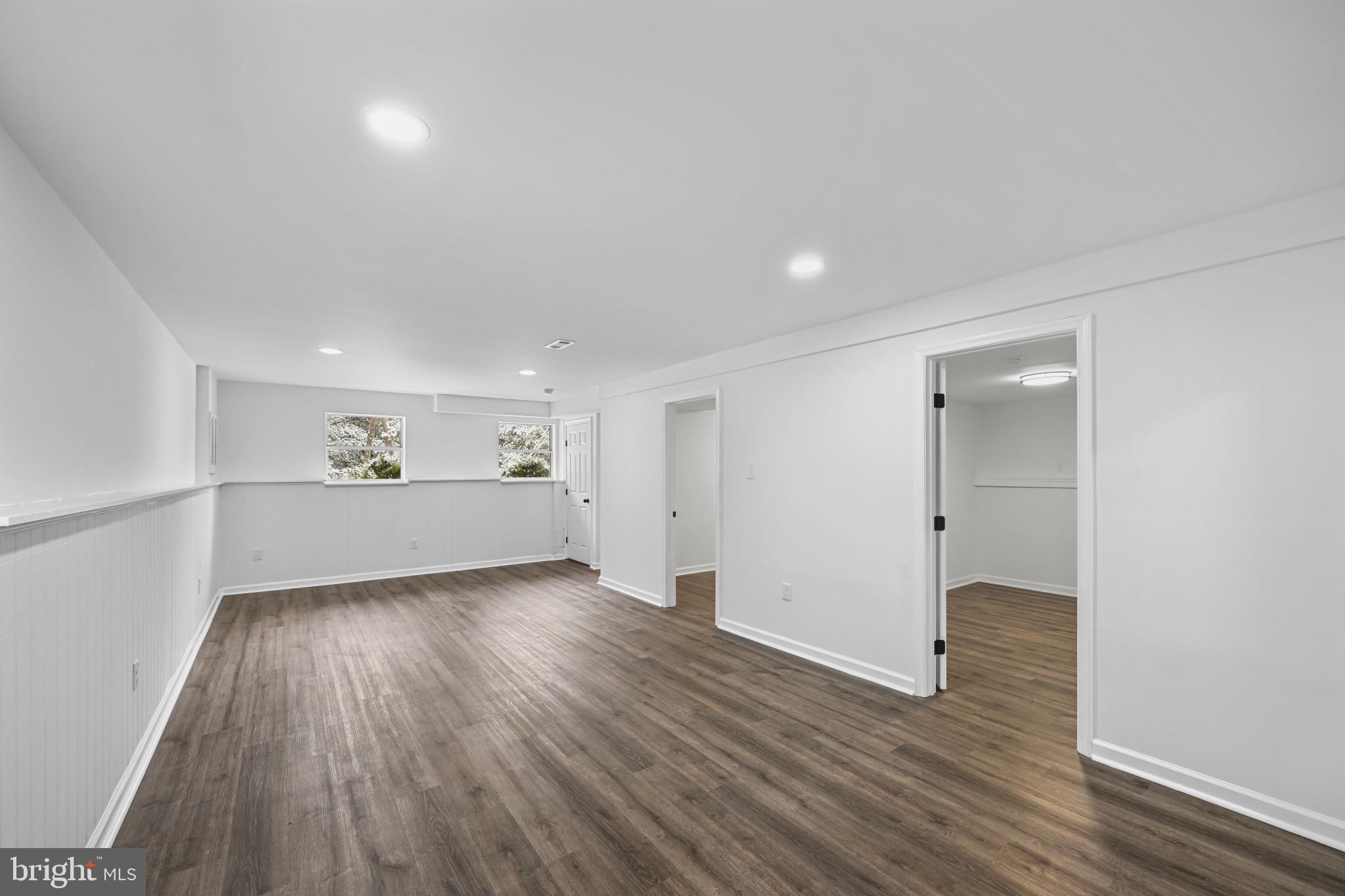 1024 Gringo Lane Lusby, MD 20657 - Photo 10 of 25 a view of a big room with wooden floor and windows
