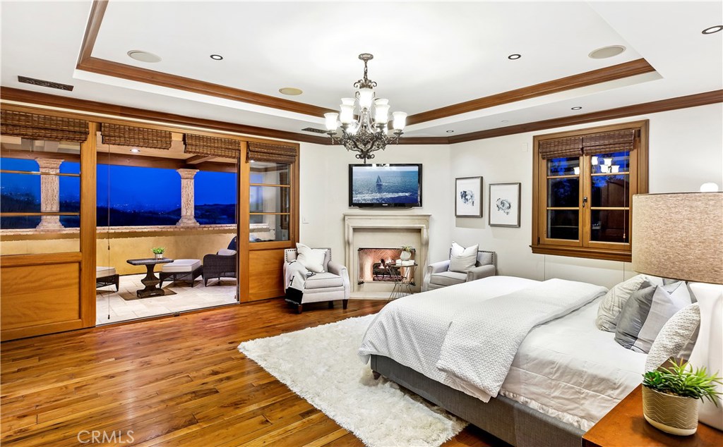 97 Canyon Creek Irvine, CA 92603 - Photo 15 of 28 a bedroom with a bed and a chandelier