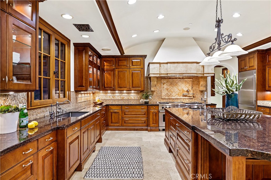 97 Canyon Creek Irvine, CA 92603 - Photo 9 of 28 a large kitchen with stainless steel appliances granite countertop a stove and large cabinets