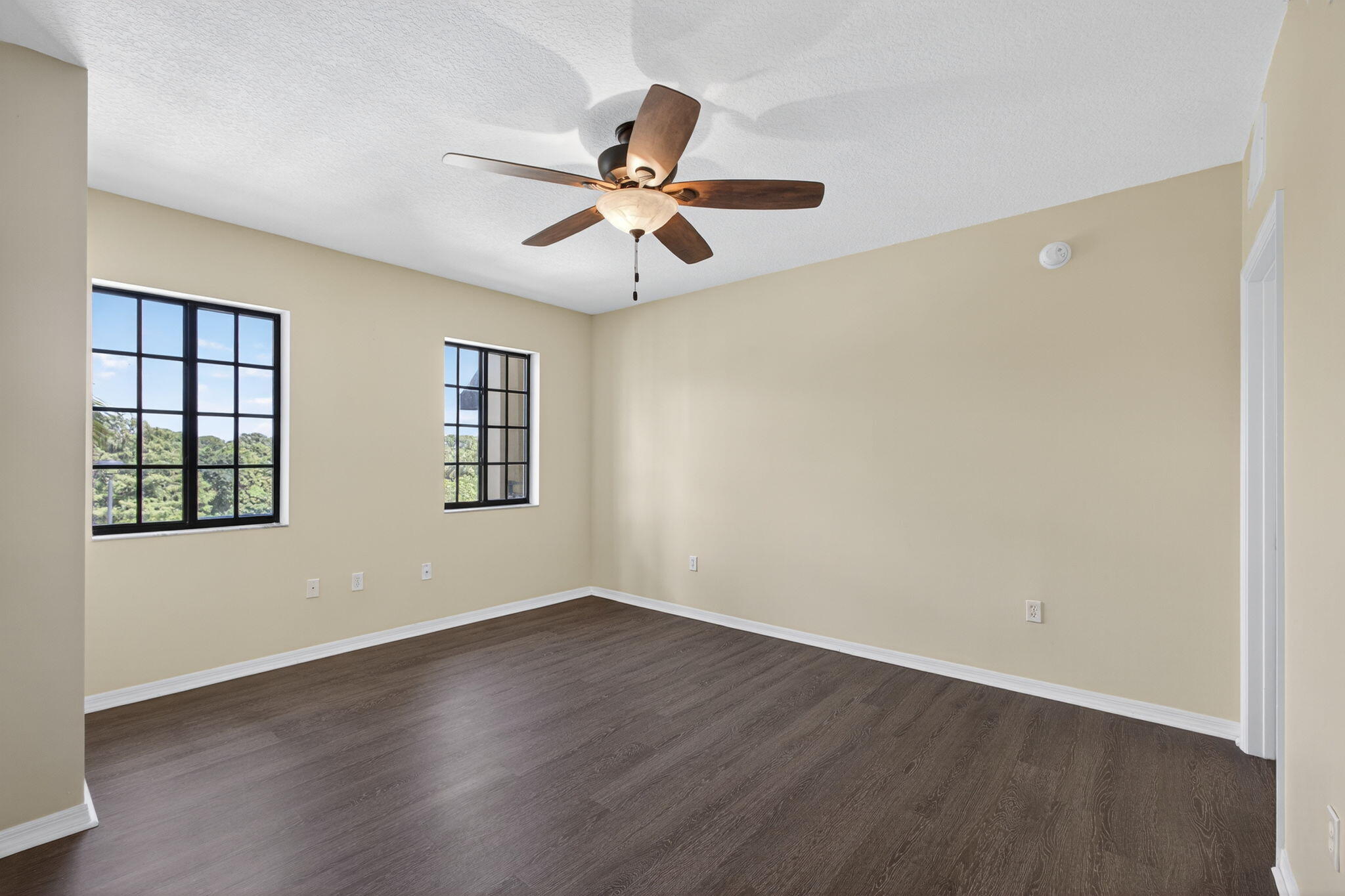 4907 Midtown Lane, Unit 1314 Palm Beach Gardens, FL 33418 - Photo 13 of 57 a view of an empty room with window and wooden floor