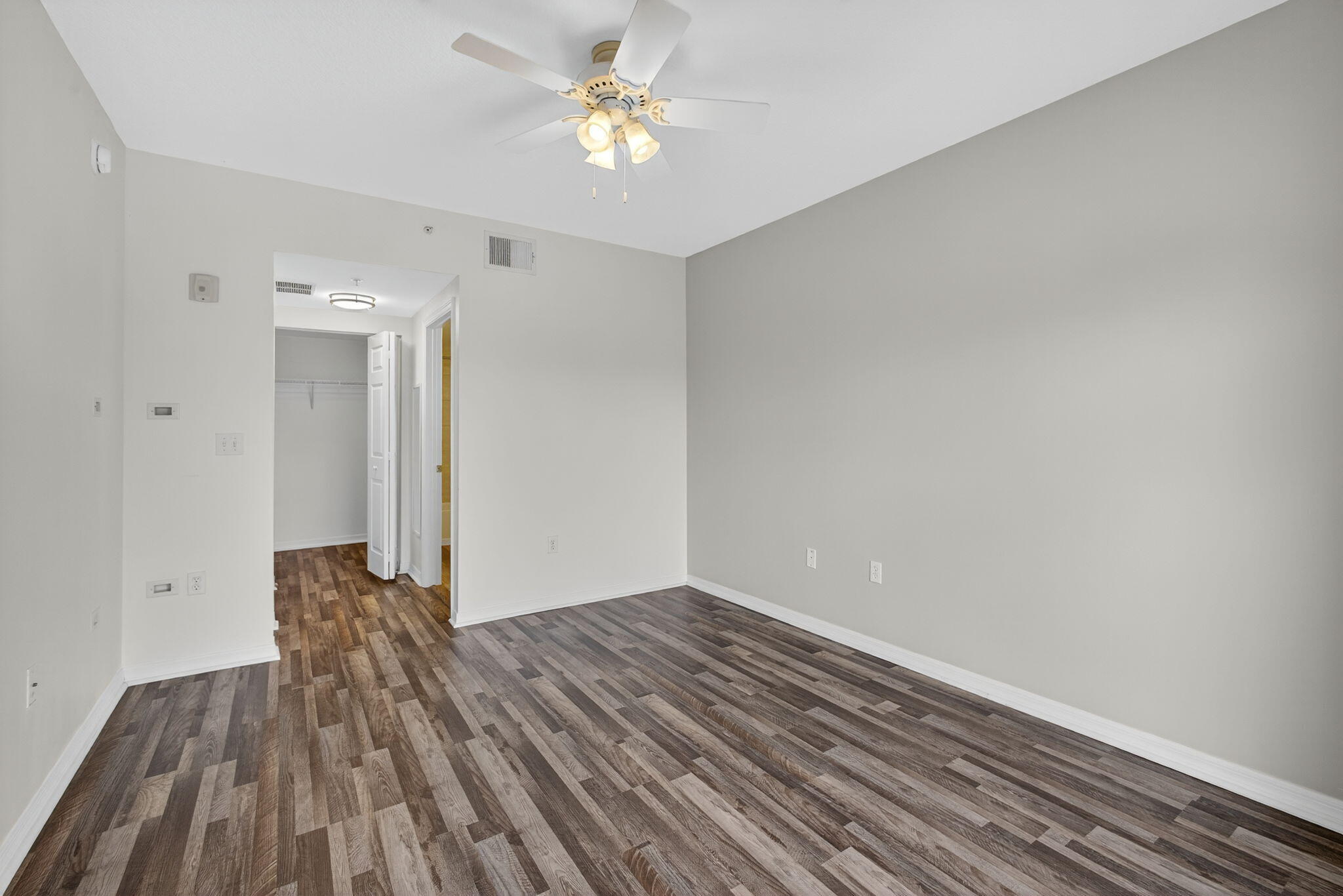 4907 Midtown Lane, Unit 1314 Palm Beach Gardens, FL 33418 - Photo 26 of 57 a view of empty room with wooden floor and ceiling fan