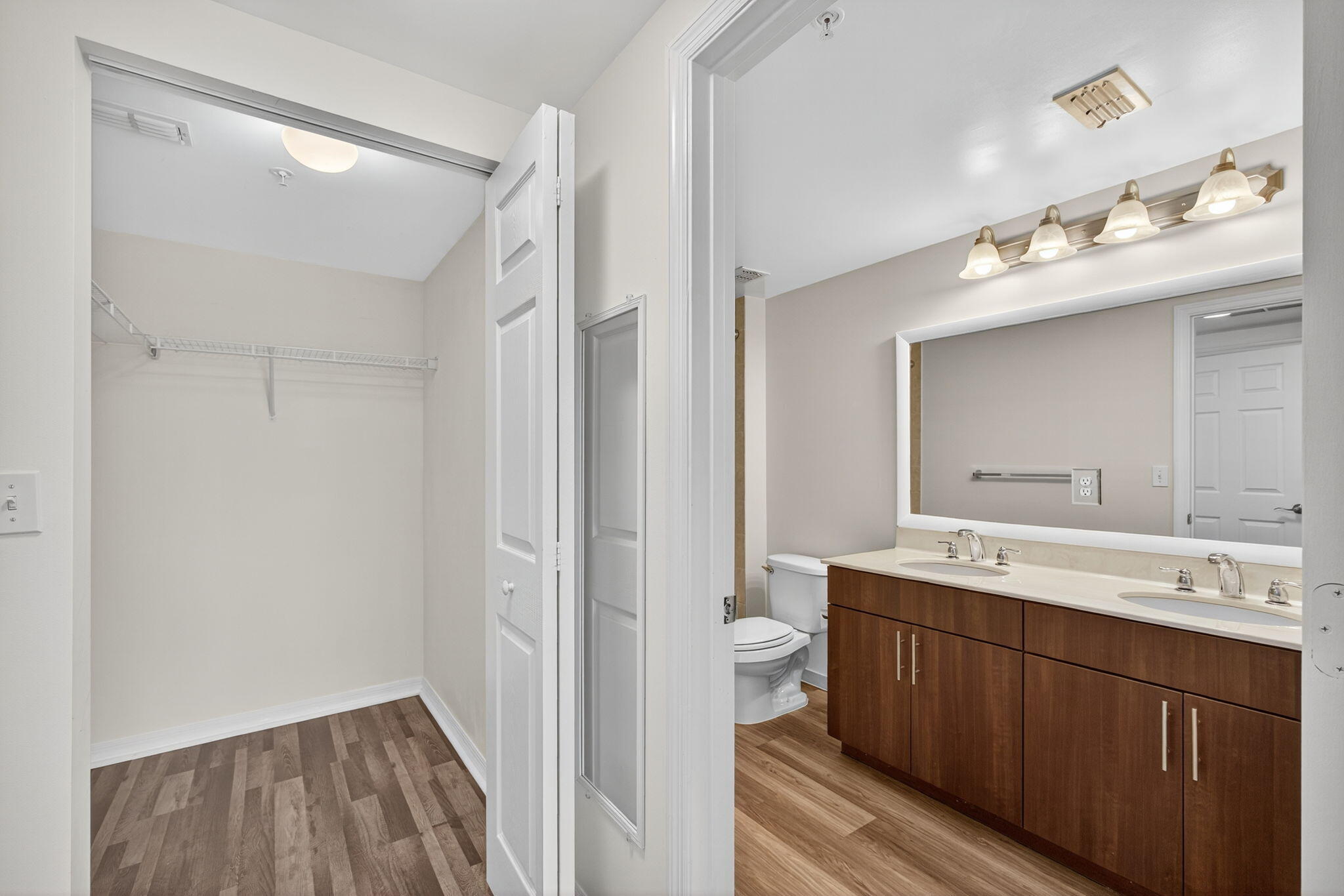 4907 Midtown Lane, Unit 1314 Palm Beach Gardens, FL 33418 - Photo 28 of 57 a bathroom with a sink mirror and a toilet