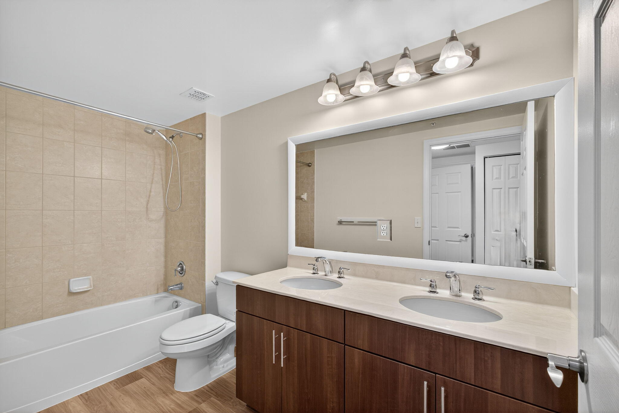 4907 Midtown Lane, Unit 1314 Palm Beach Gardens, FL 33418 - Photo 29 of 57 a bathroom with a toilet a sink a tub and a mirror