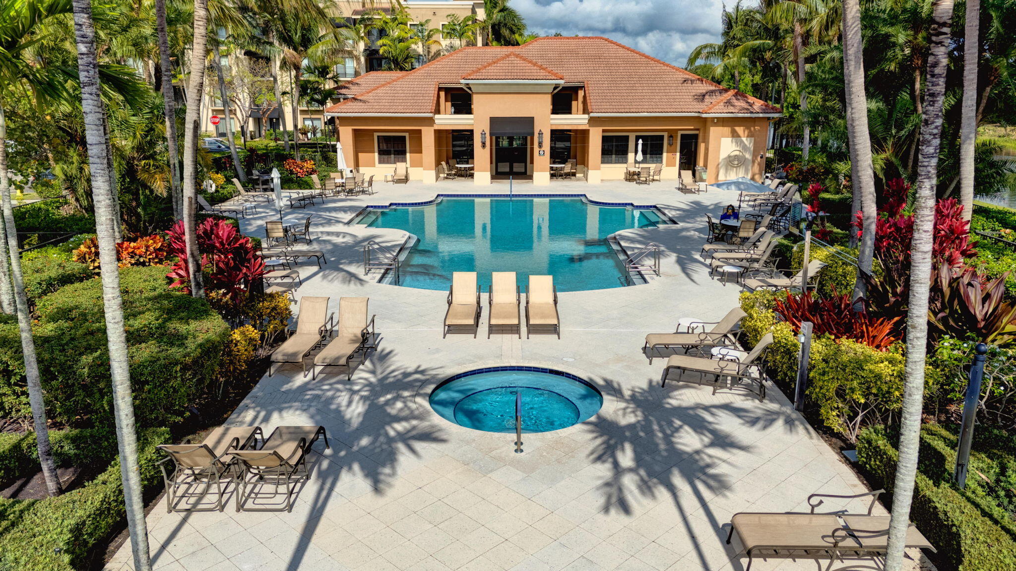 4907 Midtown Lane, Unit 1314 Palm Beach Gardens, FL 33418 - Photo 37 of 57 a aerial view of a house with table and chairs under an umbrella