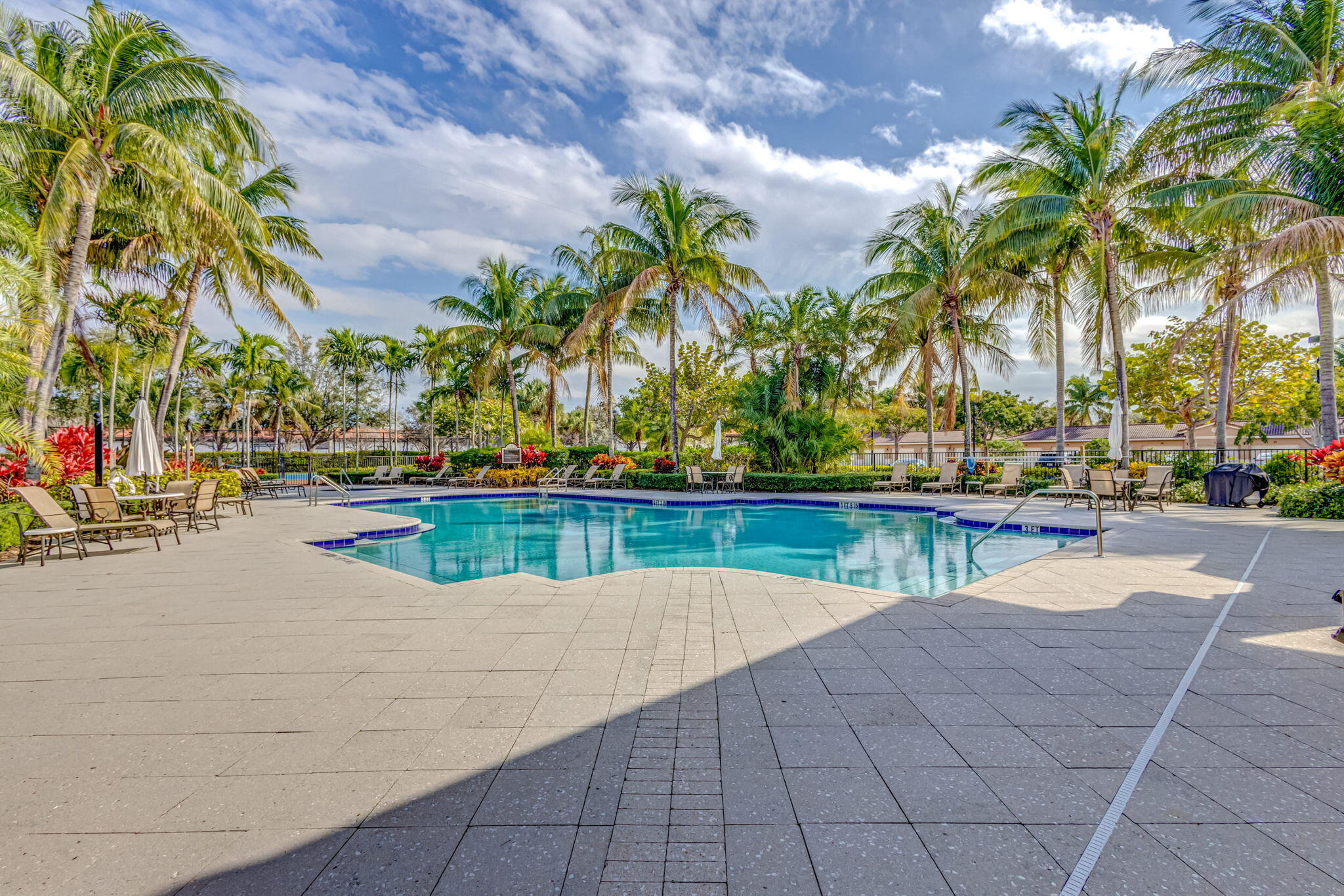 4907 Midtown Lane, Unit 1314 Palm Beach Gardens, FL 33418 - Photo 51 of 57 a view of swimming pool with a table and chair