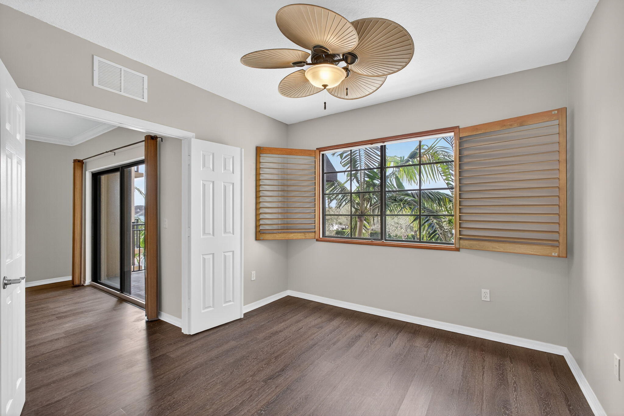 4907 Midtown Lane, Unit 1314 Palm Beach Gardens, FL 33418 - Photo 9 of 57 a view of an empty room with wooden floor and a window