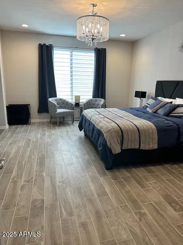 a spacious bedroom with a bed and a table