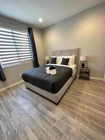 a large bed sitting in a bedroom next to a window