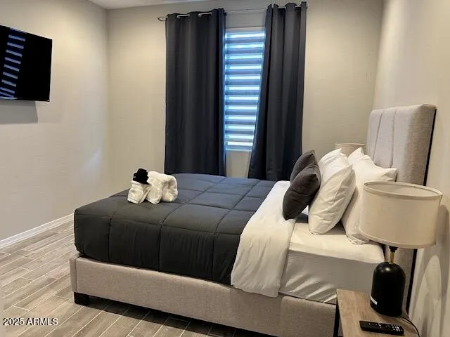 a bedroom with a bed and a chair