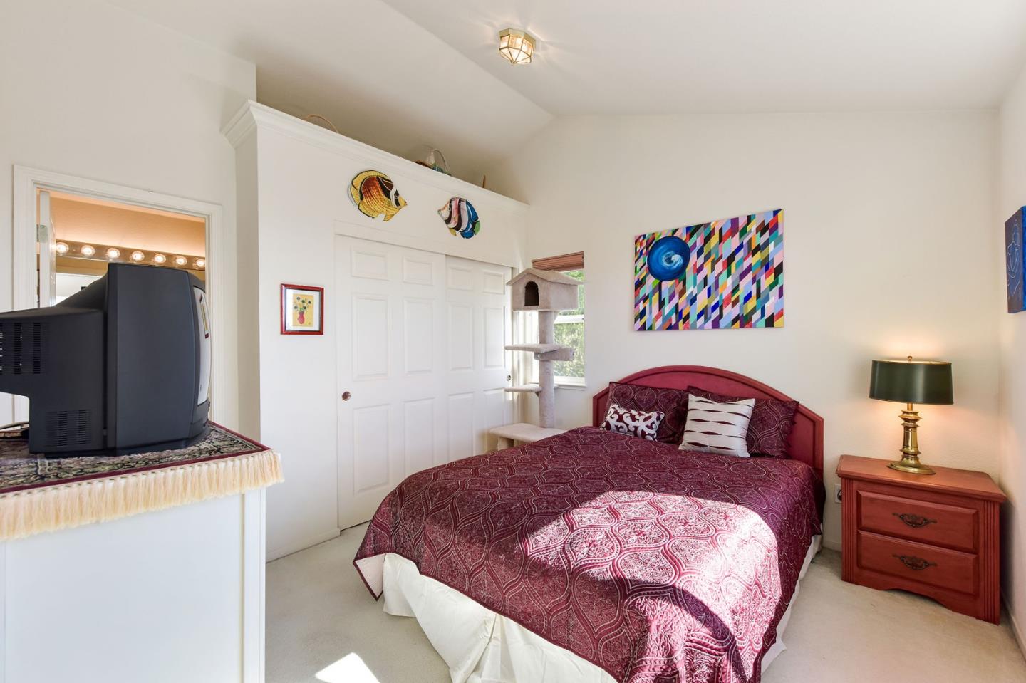 551 Monterey Road Pacifica, CA 94044 - Photo 27 of 36 a bedroom with a bed and a flat tv screen on the dresser