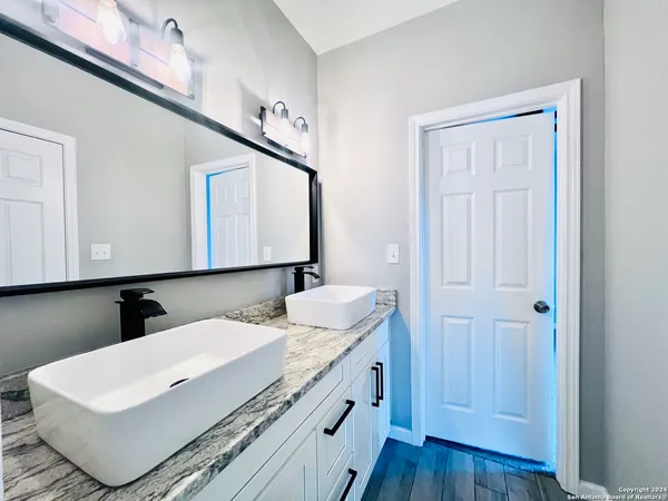 a bathroom with a sink and a mirror