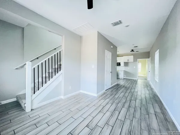 a view of a hallway with wooden floor
