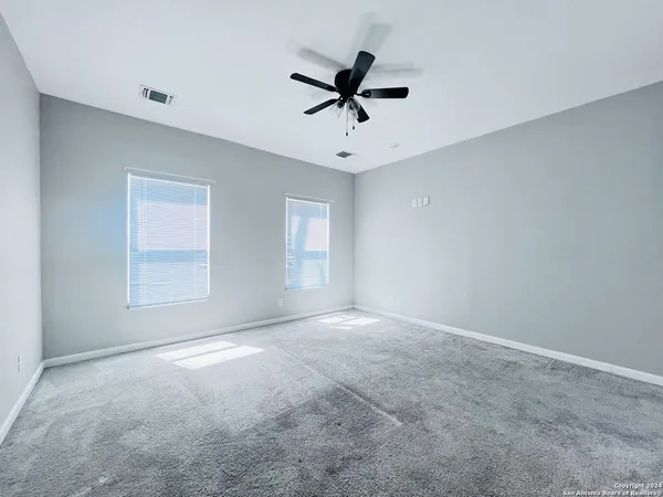 a view of room with a ceiling fan and window