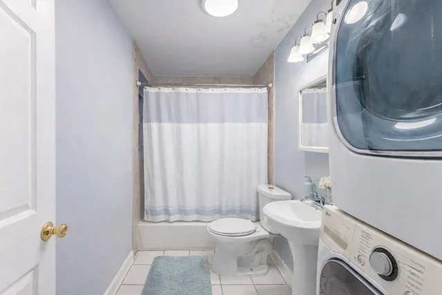 a bathroom with a toilet a sink and a mirror