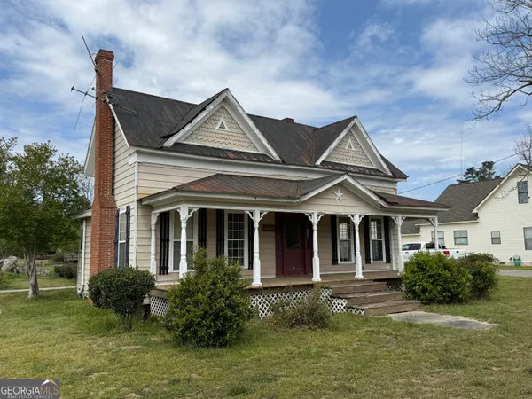 a front view of a house with garden