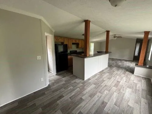 a kitchen with granite countertop a refrigerator and a sink