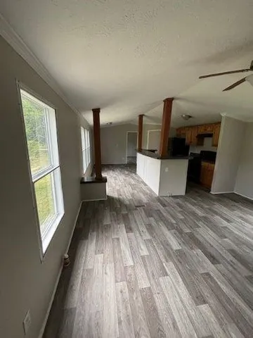 a view of kitchen with furniture and wooden floor