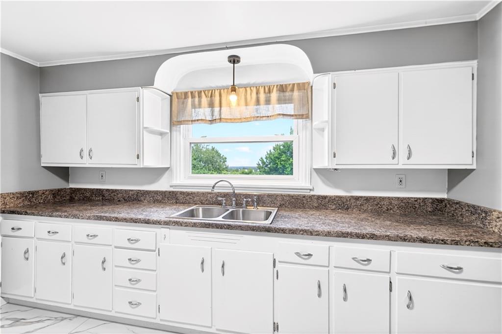 124 Bunker Hill Road Aliquippa, PA 15001 - Photo 16 of 37 a kitchen with granite countertop white cabinets and a window
