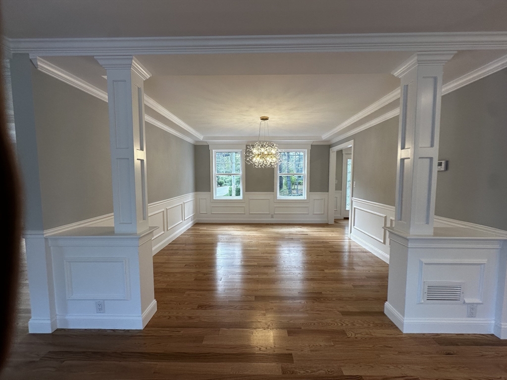 56 Dudley Road Billerica, MA 01821 - Photo 5 of 29 a view of an empty room with wooden floor and a window