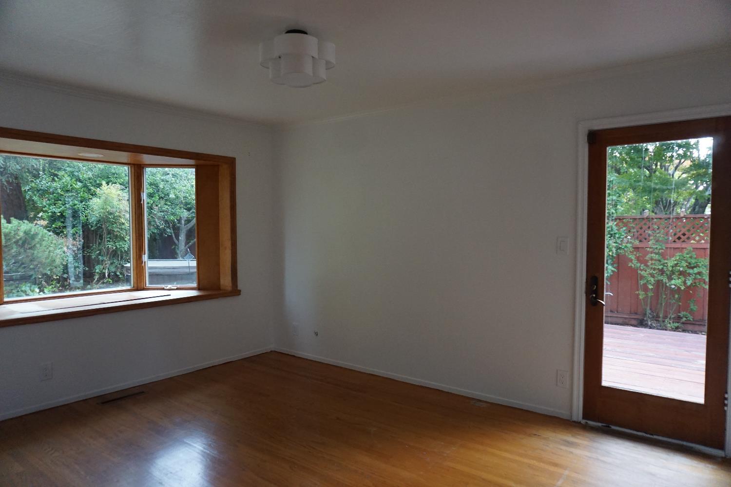 1917 Wingate Way Hayward, CA 94541 - Photo 11 of 15 an empty room with wooden floor and windows