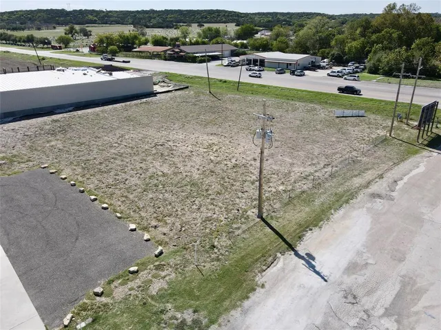 a view of a swimming pool with lawn chairs and plants