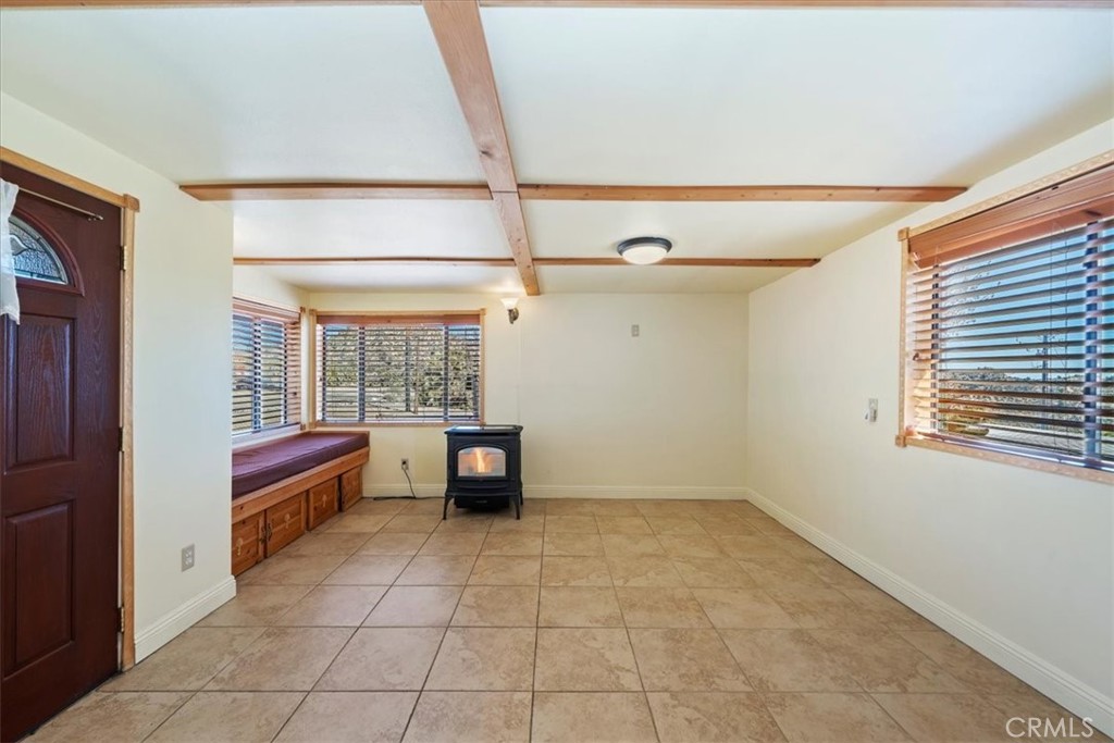 7337 Sequoia Road Wrightwood, CA 92397 - Photo 8 of 52 a view of an empty room with a fireplace and a window