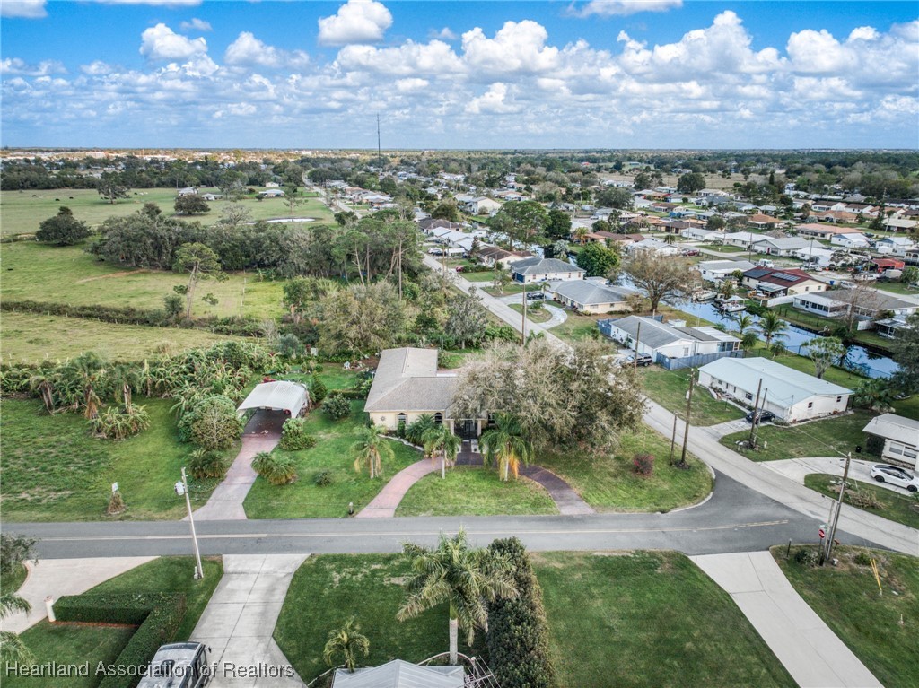3534 Tubbs Road Sebring, FL 33870 - Photo 4 of 43 Over 1/2 acre of land. Easy to care for landscape, fruit trees, and herb and veggie garden.