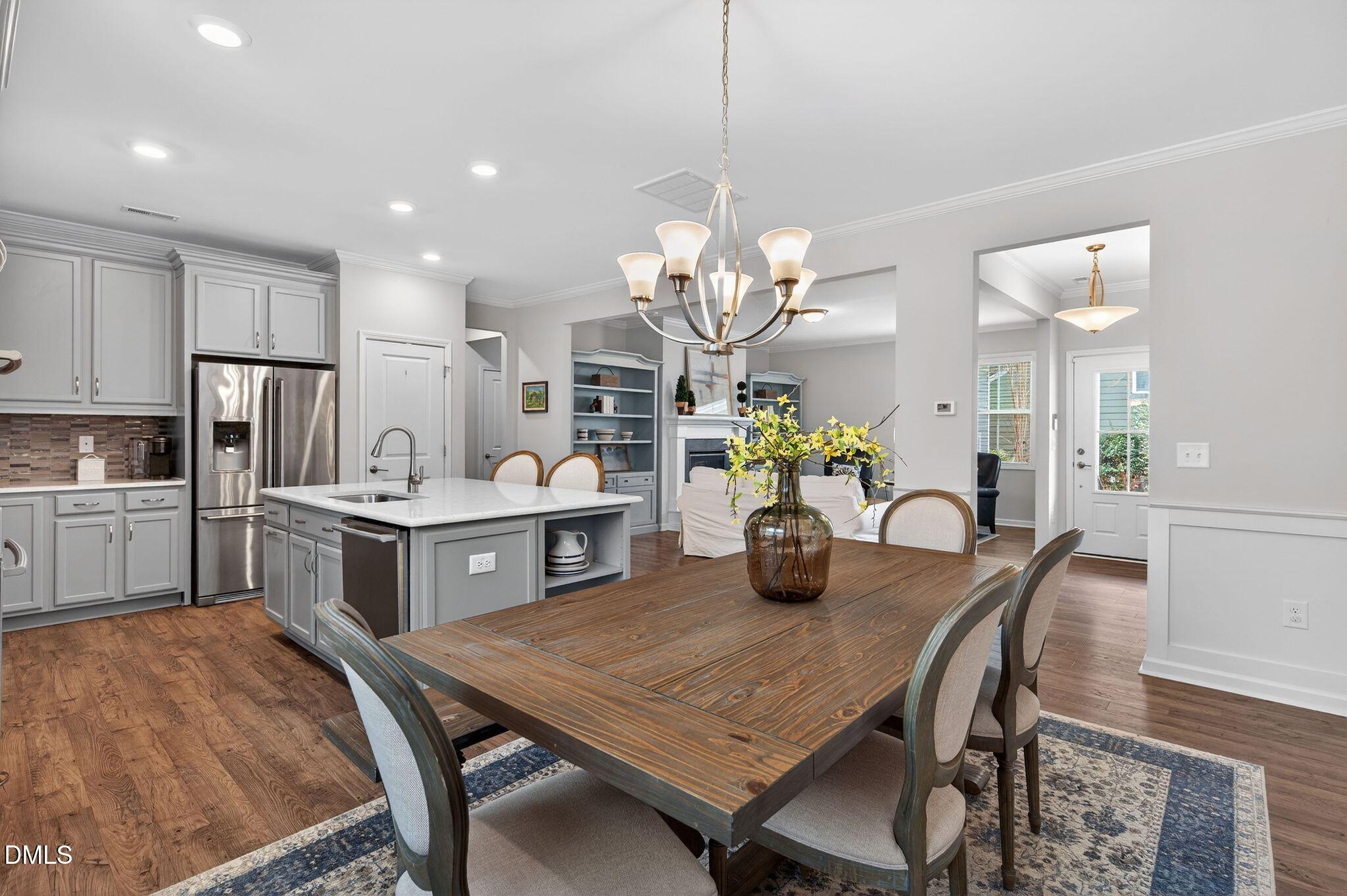 528 Spring Flower Court Cary, NC 27511 - Photo 15 of 51 a kitchen with sink table and chairs