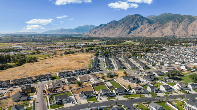2706 West Maple Street, Unit 285 Mapleton, UT 84664 - Photo 35 of 36 Expansive neighborhood featuring a variety of residential properties, mountainous terrain, and open fields under a clear sky
