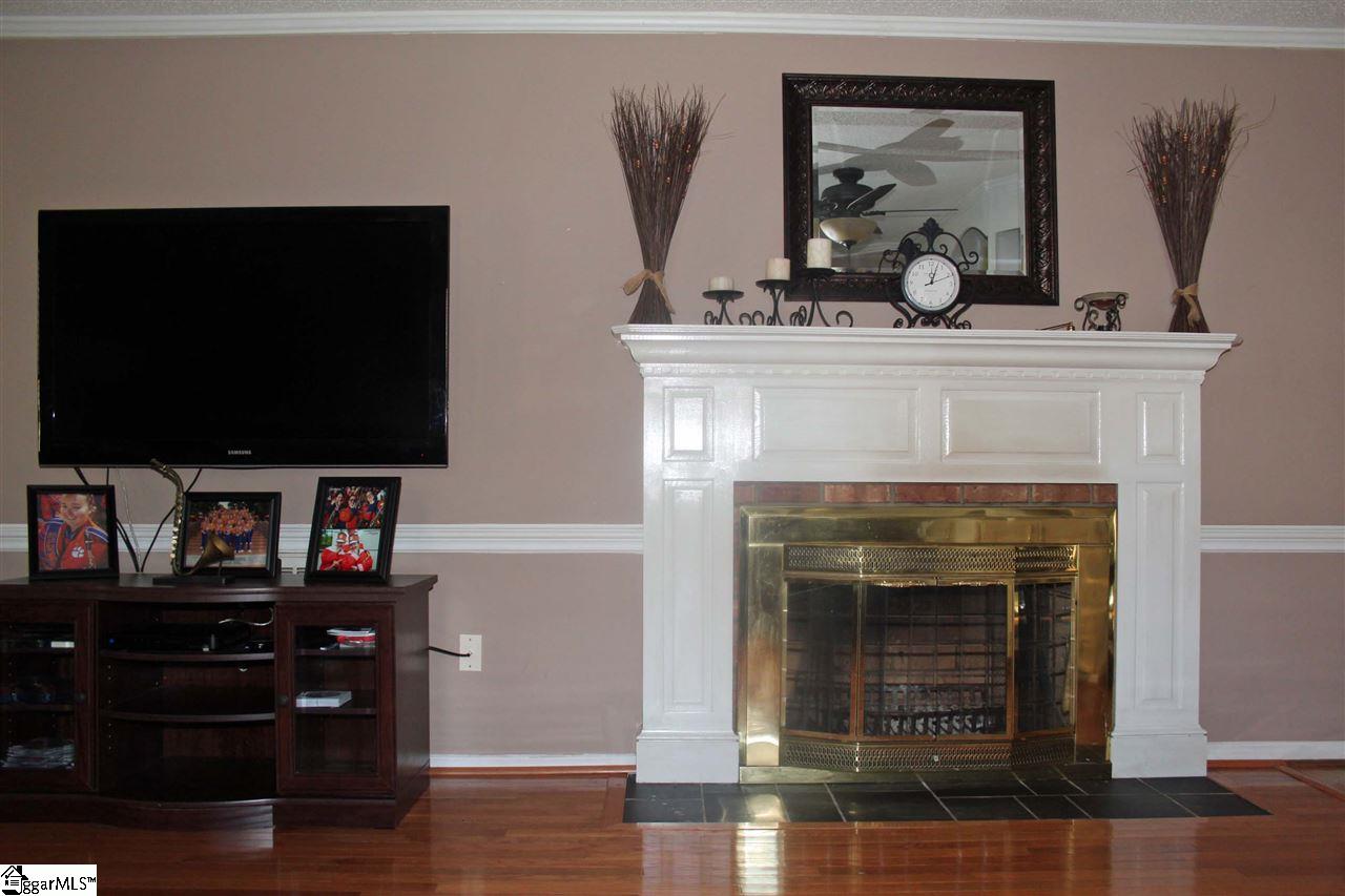 701 Hunters Hill Road Simpsonville, SC 29680 - Photo 6 of 36 The living room is 19X13 with crown molding, hardwood floors, a fireplace, built in book shelves and cabinets along with a Bay window.