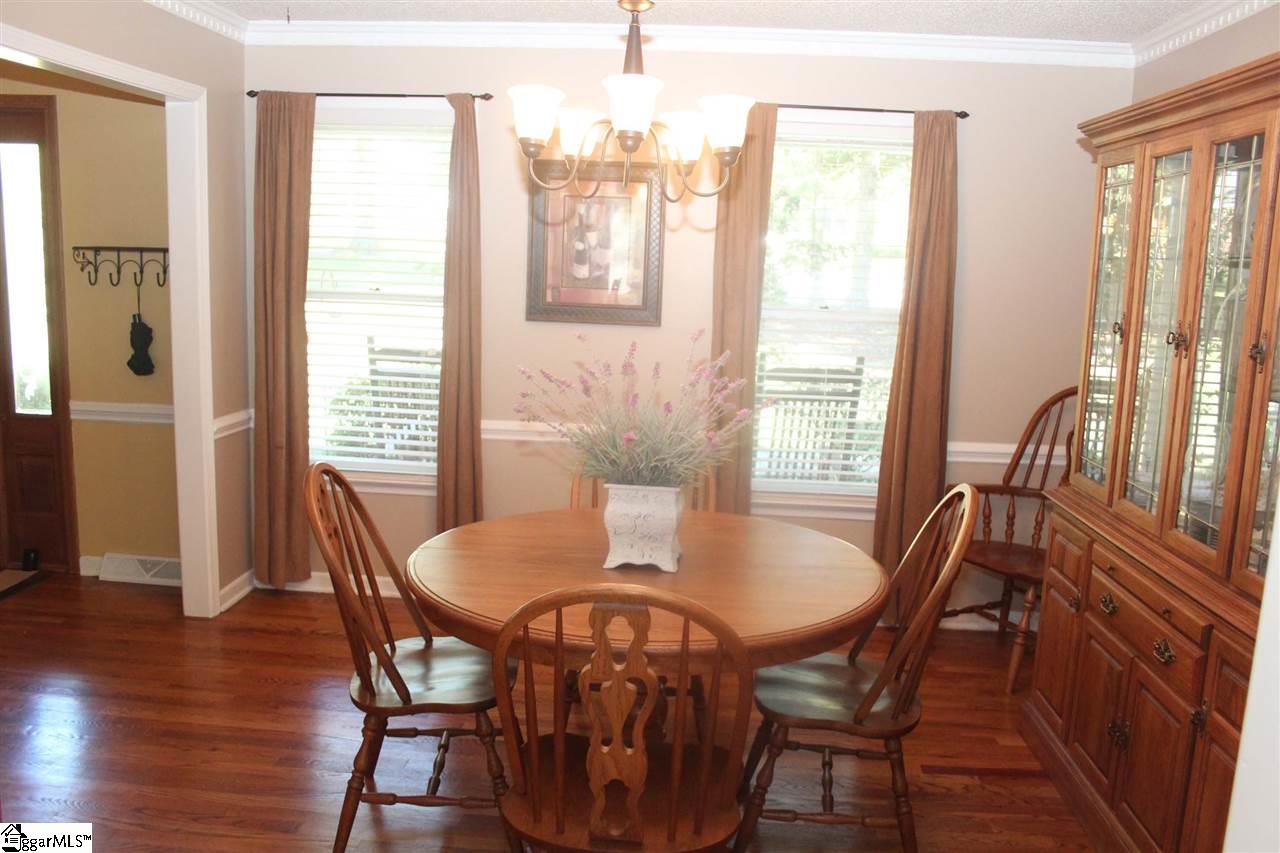 701 Hunters Hill Road Simpsonville, SC 29680 - Photo 7 of 36 The Dining Room is 12X12 and is located to the left of the foyer and has direct access to the kitchen. It is complimented by hardwood floors and crown and dentil molding.