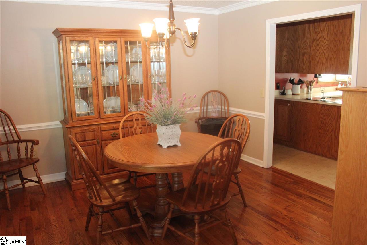 701 Hunters Hill Road Simpsonville, SC 29680 - Photo 8 of 36 The Dining Room is 12X12 and is located to the left of the foyer and has direct access to the kitchen. It is complimented by hardwood floors and crown and dentil molding.