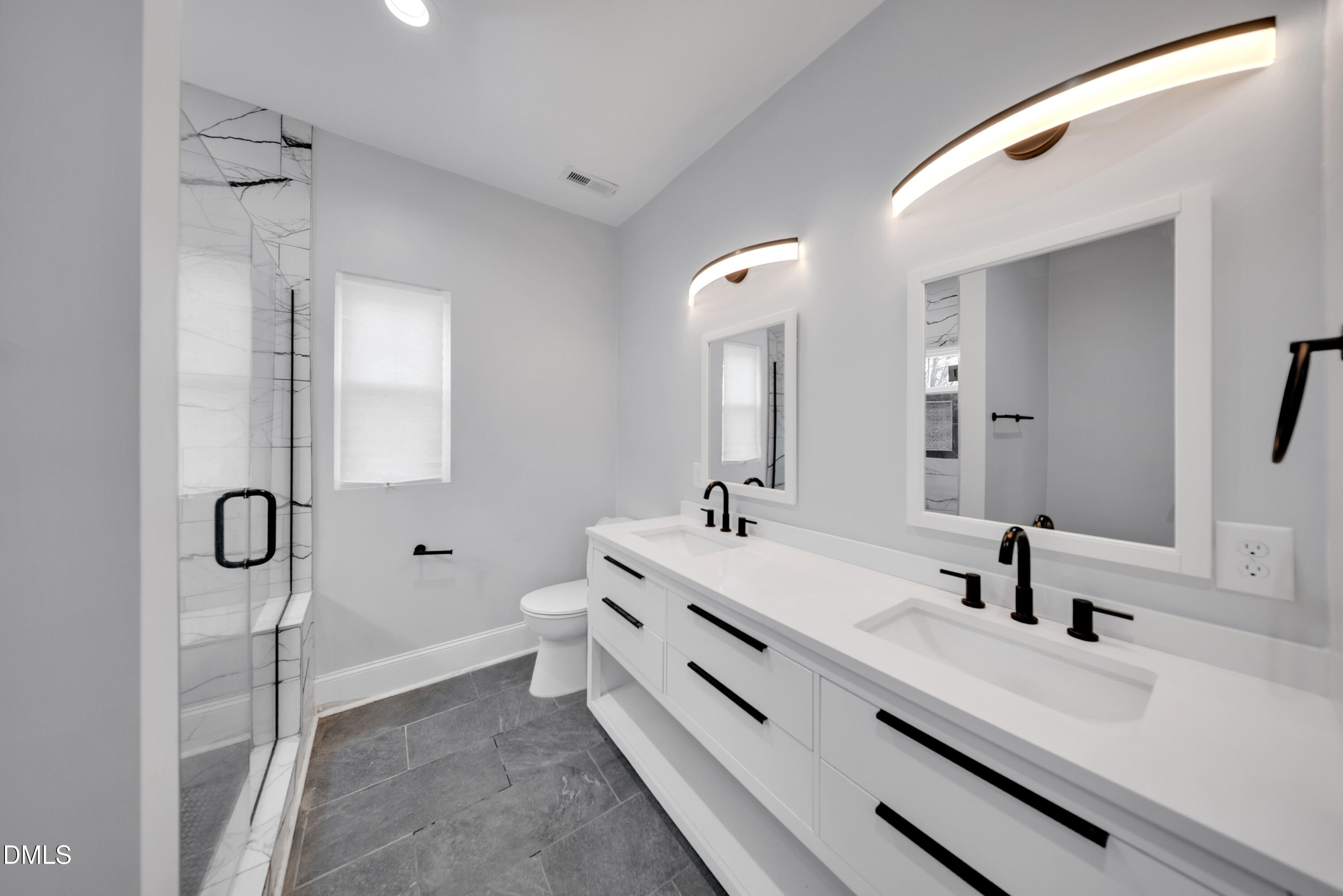 3908 Booker Avenue Durham, NC 27713 - Photo 37 of 71 a bathroom with a double vanity sink mirror and shower