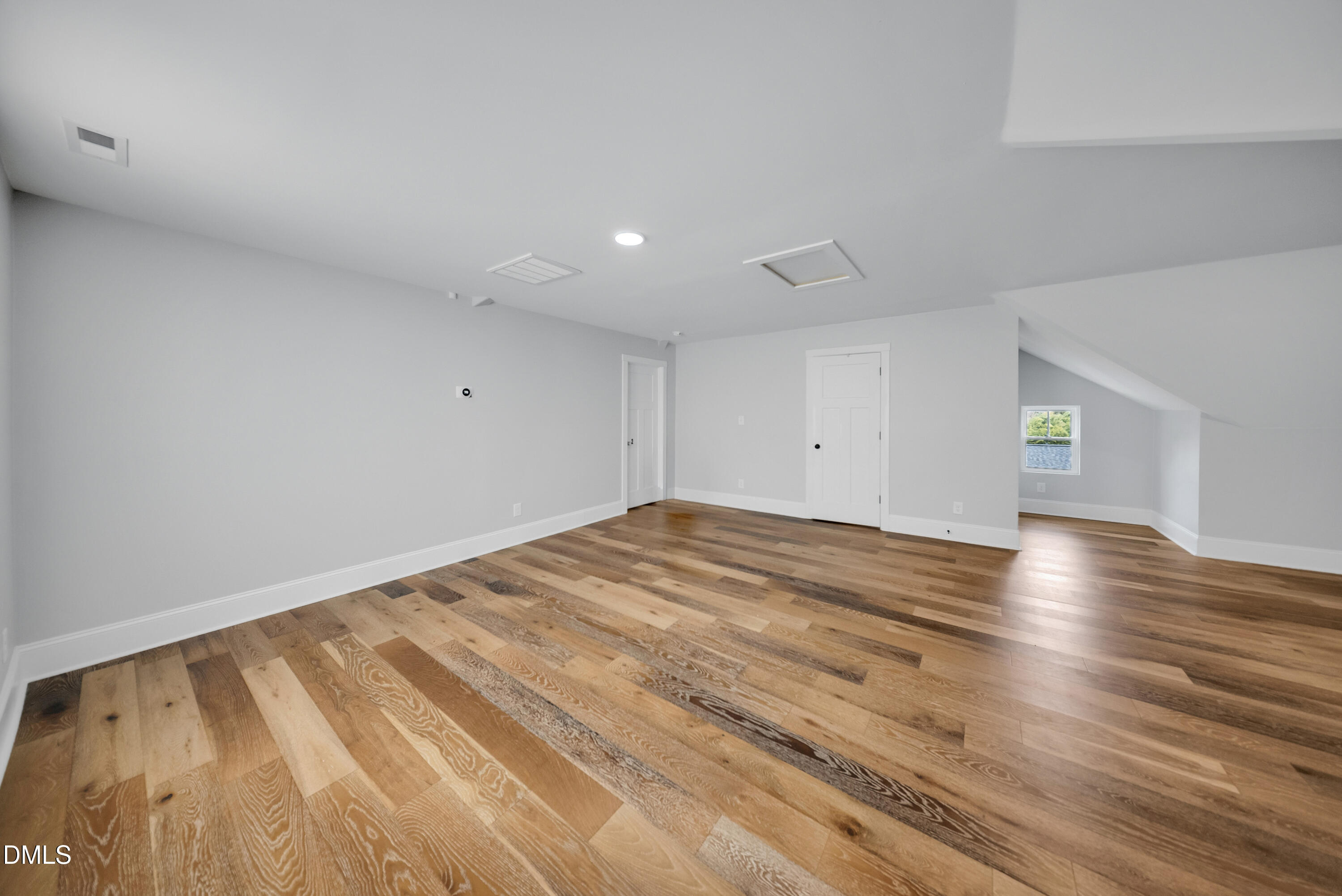 3908 Booker Avenue Durham, NC 27713 - Photo 45 of 71 a view of empty room with wooden floor and fan