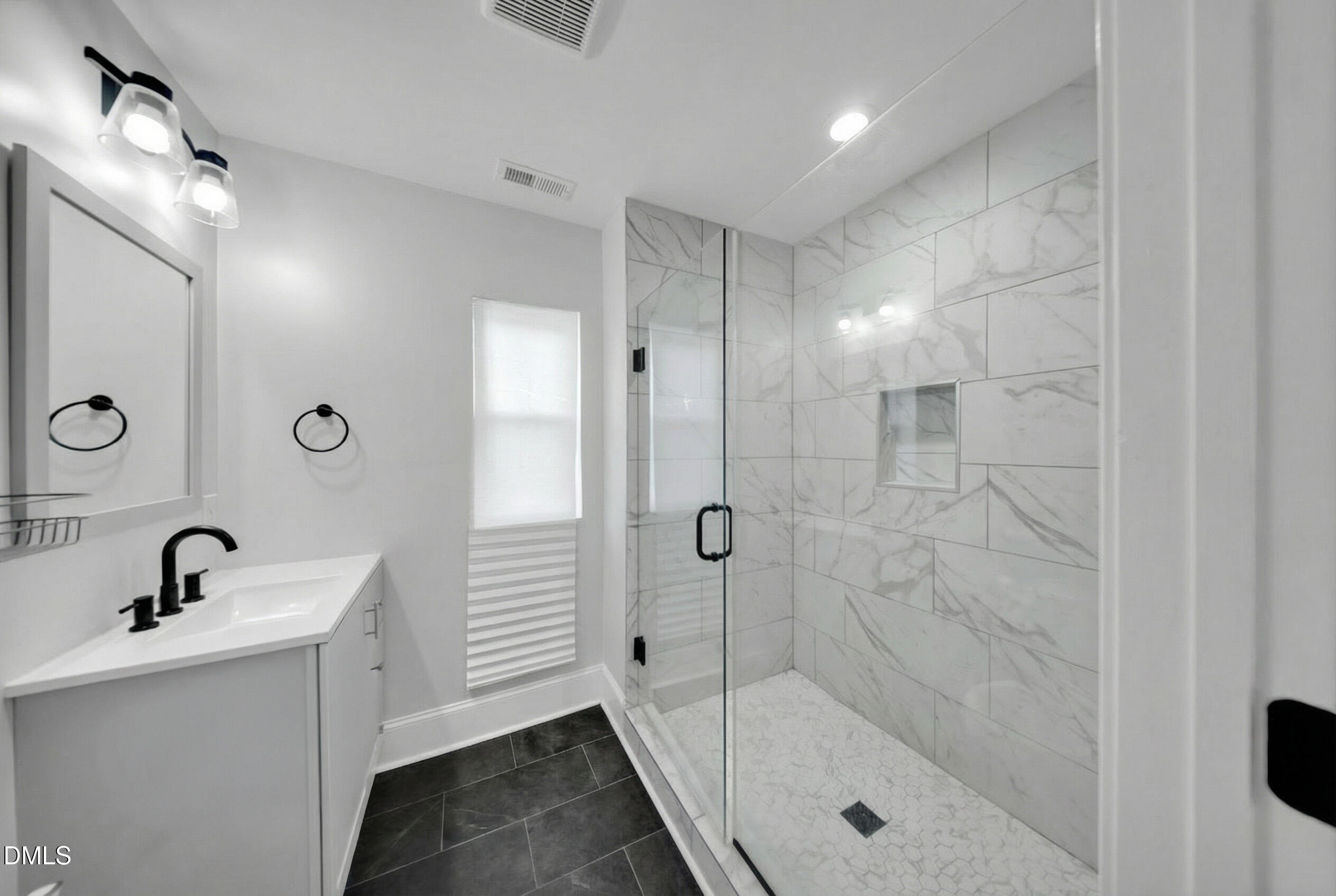 3908 Booker Avenue Durham, NC 27713 - Photo 47 of 71 a bathroom with a shower a sink and mirror