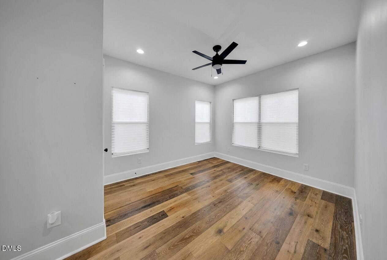 3908 Booker Avenue Durham, NC 27713 - Photo 52 of 71 a view of empty room with wooden floor and fan