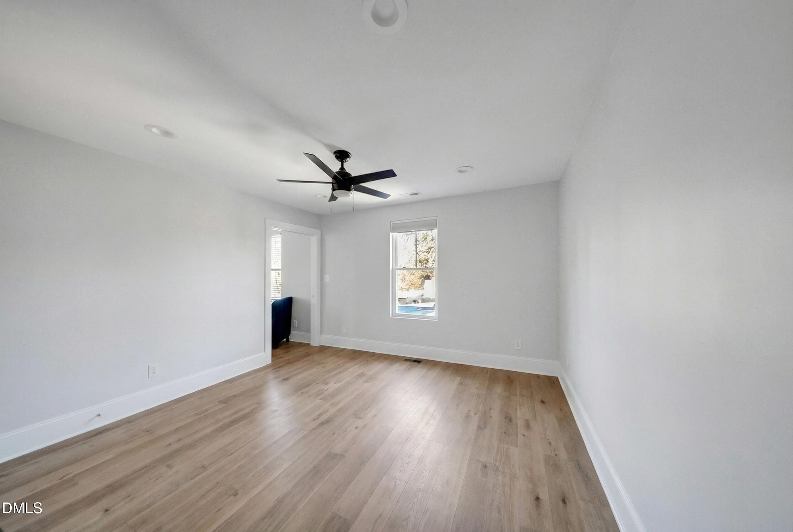 3908 Booker Avenue Durham, NC 27713 - Photo 62 of 71 an empty room with wooden floor ceiling fan and windows