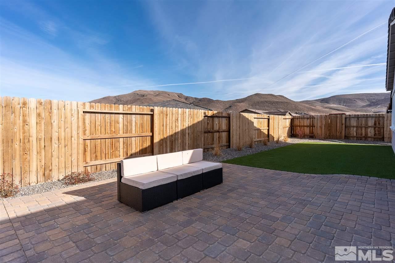 2337 Stone Rise Road Reno, NV 89521 - Photo 25 of 25 a view of patio with a table and chairs under an umbrella with a small yard