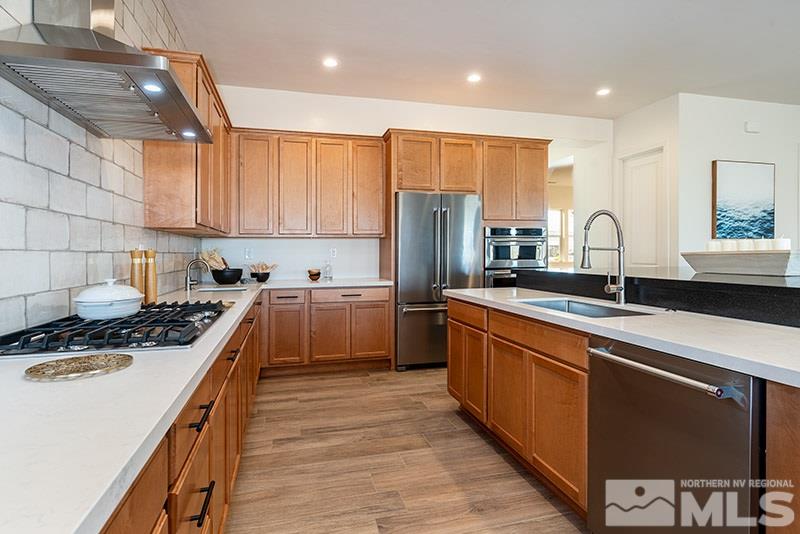 2337 Stone Rise Road Reno, NV 89521 - Photo 8 of 25 a kitchen with kitchen island granite countertop a sink stainless steel appliances and cabinets