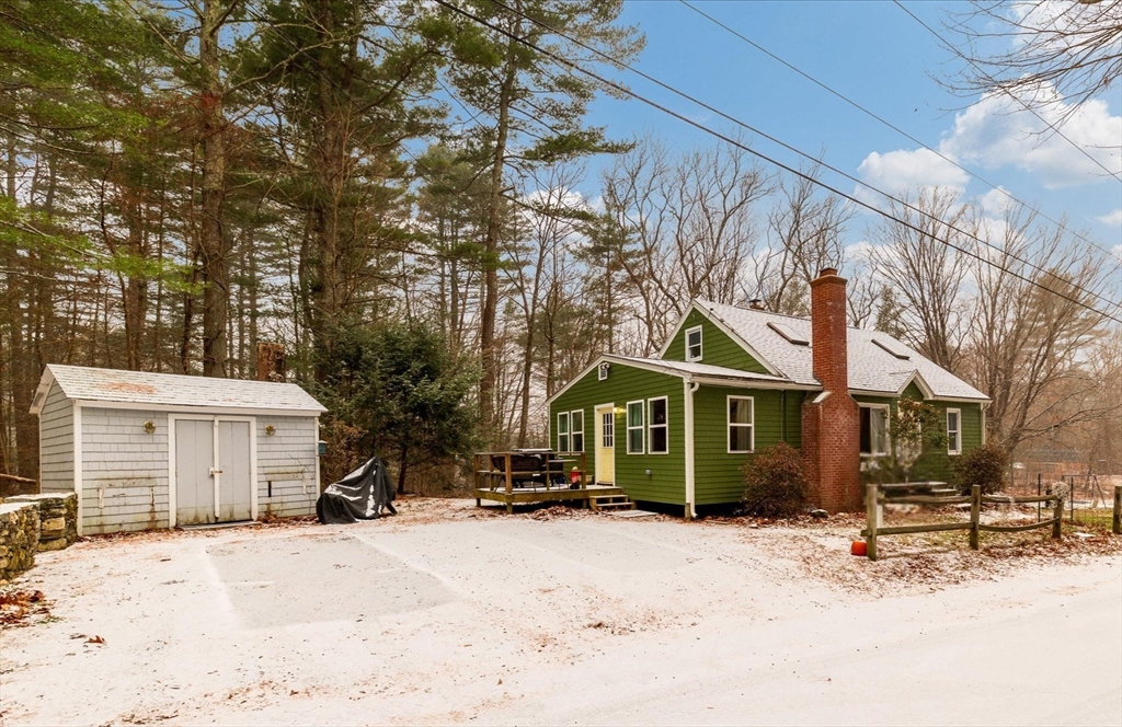 13 Morse Road Holland, MA 01521 - Photo 2 of 25 a front view of a house with a yard covered in snow