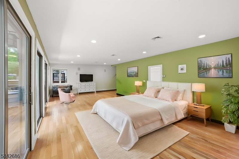 156 Kingsland Road Boonton, NJ 07005 - Photo 17 of 39 a bedroom with a large bed and a chandelier