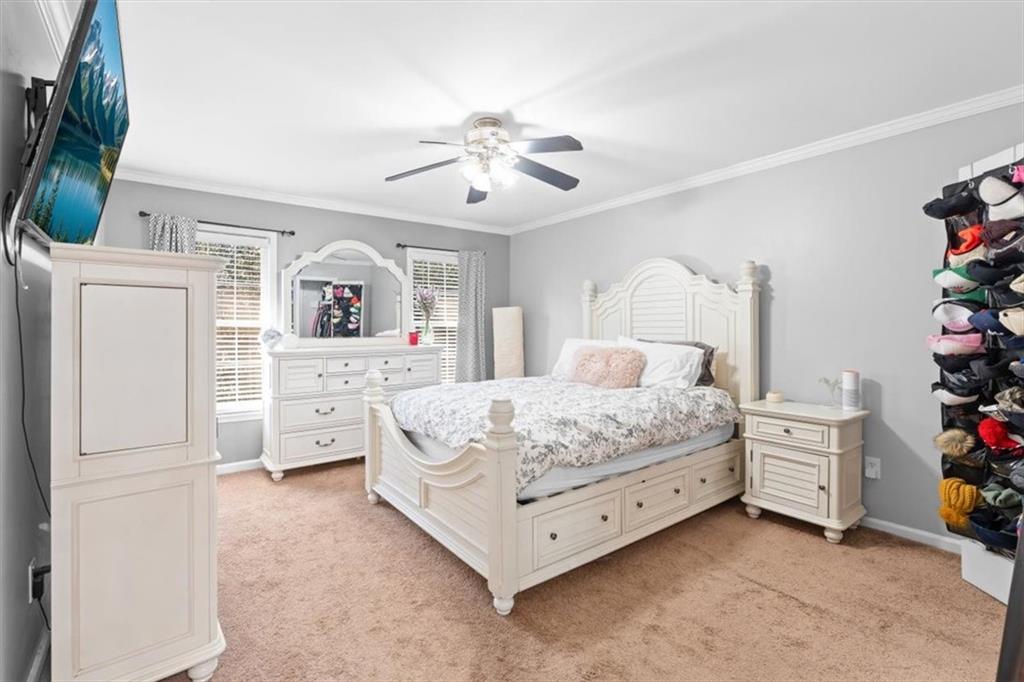 1101 Collier Road Northwest, Unit T5 Atlanta, GA 30318 - Photo 17 of 32 a bedroom with a bed dresser and flat screen tv