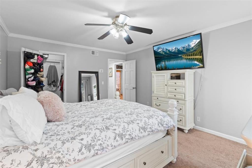 1101 Collier Road Northwest, Unit T5 Atlanta, GA 30318 - Photo 18 of 32 a bedroom with a bed and a flat screen tv