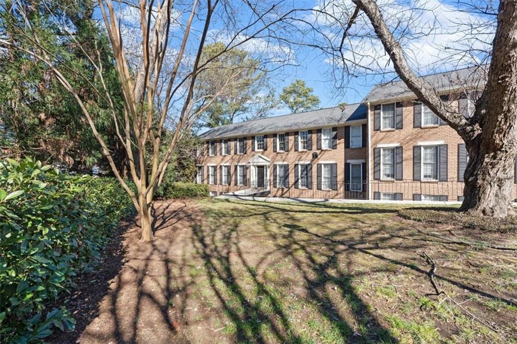1101 Collier Road Northwest, Unit T5 Atlanta, GA 30318 - Photo 2 of 32 a view of a house with a yard