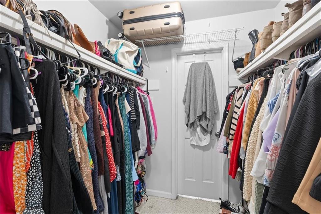 1101 Collier Road Northwest, Unit T5 Atlanta, GA 30318 - Photo 21 of 32 a view of walk in closet with clothes