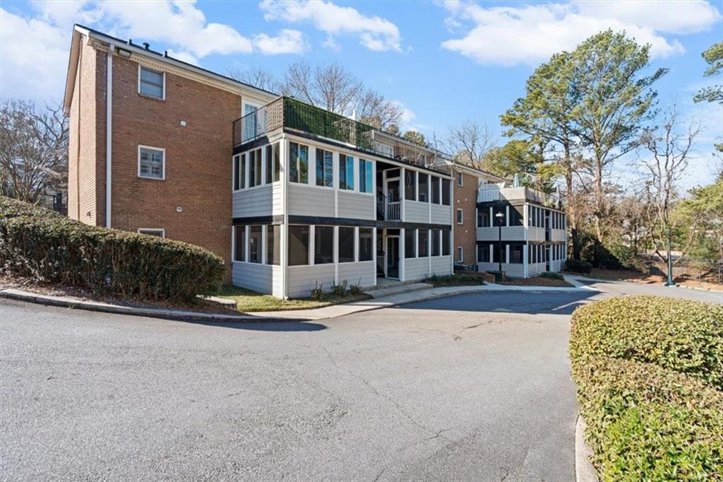1101 Collier Road Northwest, Unit T5 Atlanta, GA 30318 - Photo 24 of 32 a view of a building with a yard